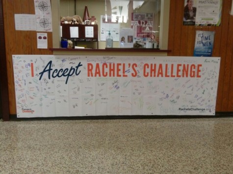 A banner hangs in the hall of AHS displaying signatures of students who have accepted Rachel's Challenge.