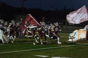 The Ada Cougar football team charges onto the field for their match up against Bristow.