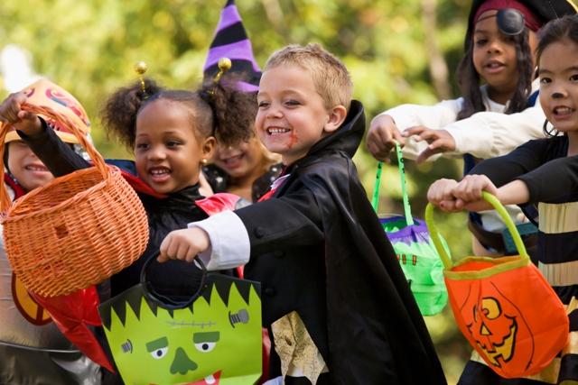 Multi-ethnic children dressed in Halloween costumes