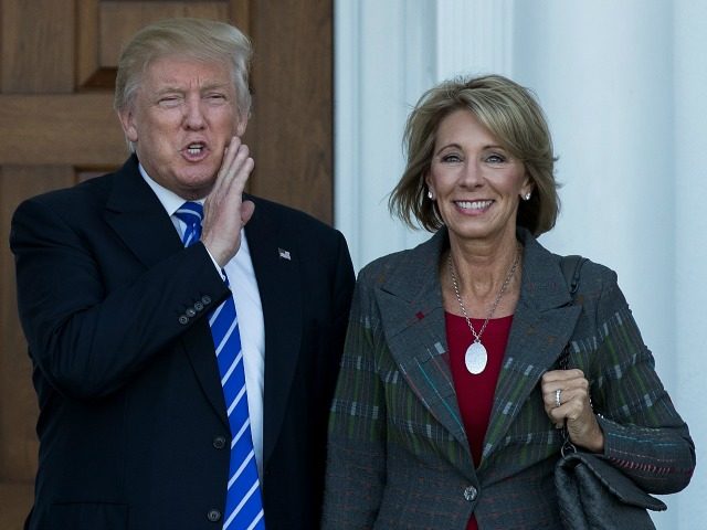 Newly elected Secretary of Education Nancy DeVos stand alongside President Donald Trump.
