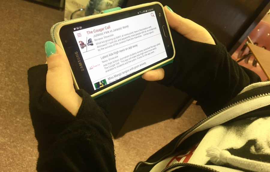 Ada High Scghool student checks out The Cougar Call App