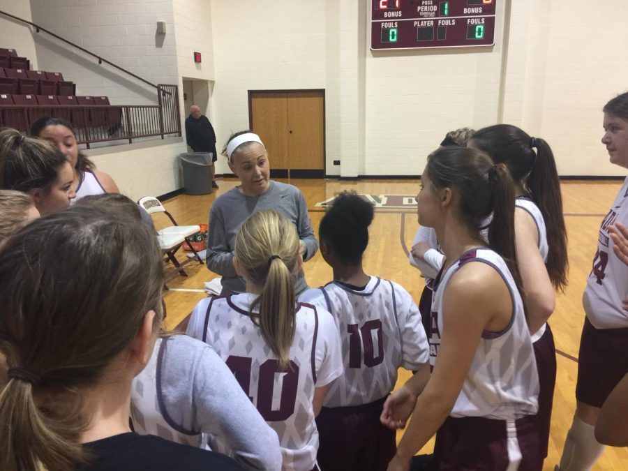 Head coach Christie Jennings huddles with her team during a pre-season scrimmage. 