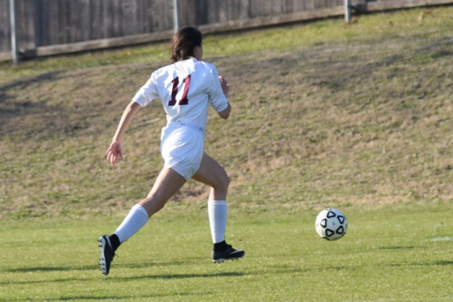 Angelina Hernandez sprints across the field to get to the ball.