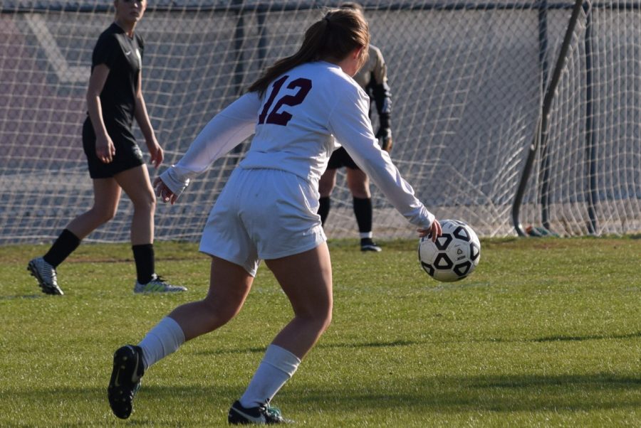 Kyla Mitchel kicks the ball hoping to make it in the goal.