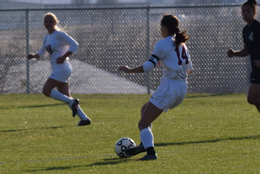 Colee Rogers has the ball and is making her way to the goal.