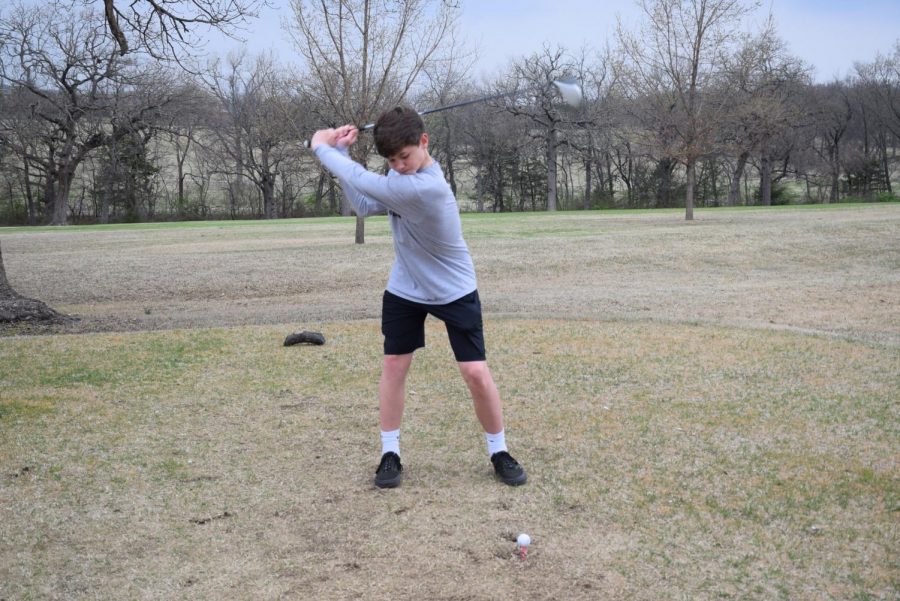 Junior Varsity Ian McClure in his back swing to properly send it.