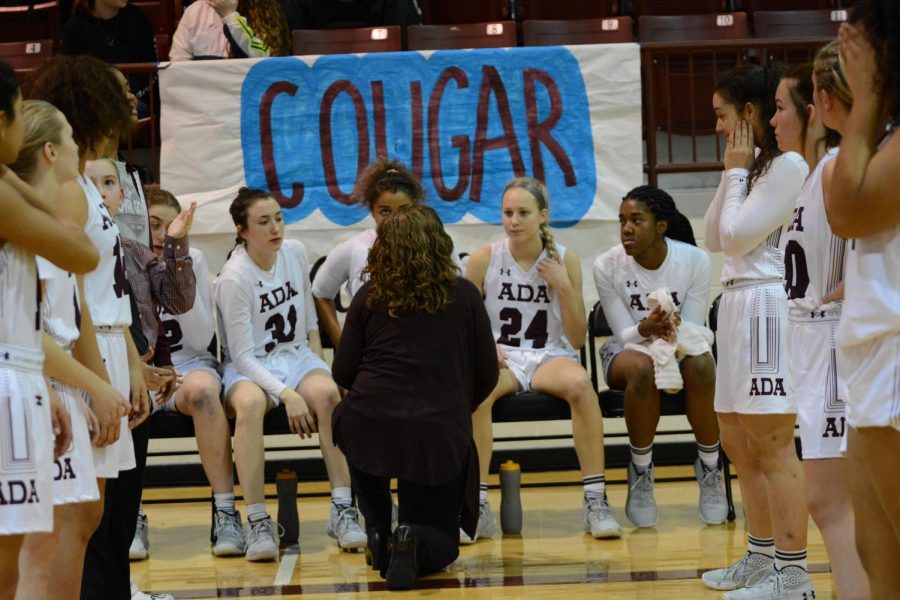 Boosting up the confidence of the Lady Cougars, head coach Christie Jennings goes over game plans before the game. Jennings does this before each game with all players.